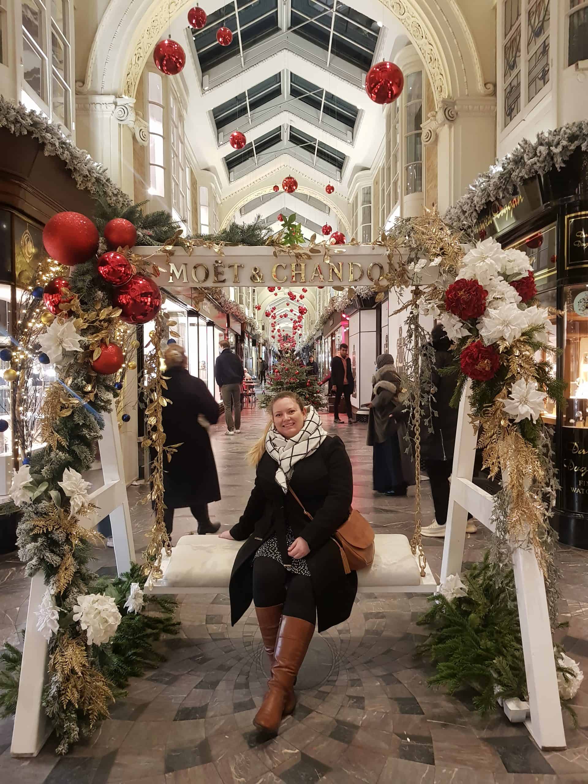 A Moet and Chandon champagne sign with a swing seat and Christmas decorative garlands around the seat.