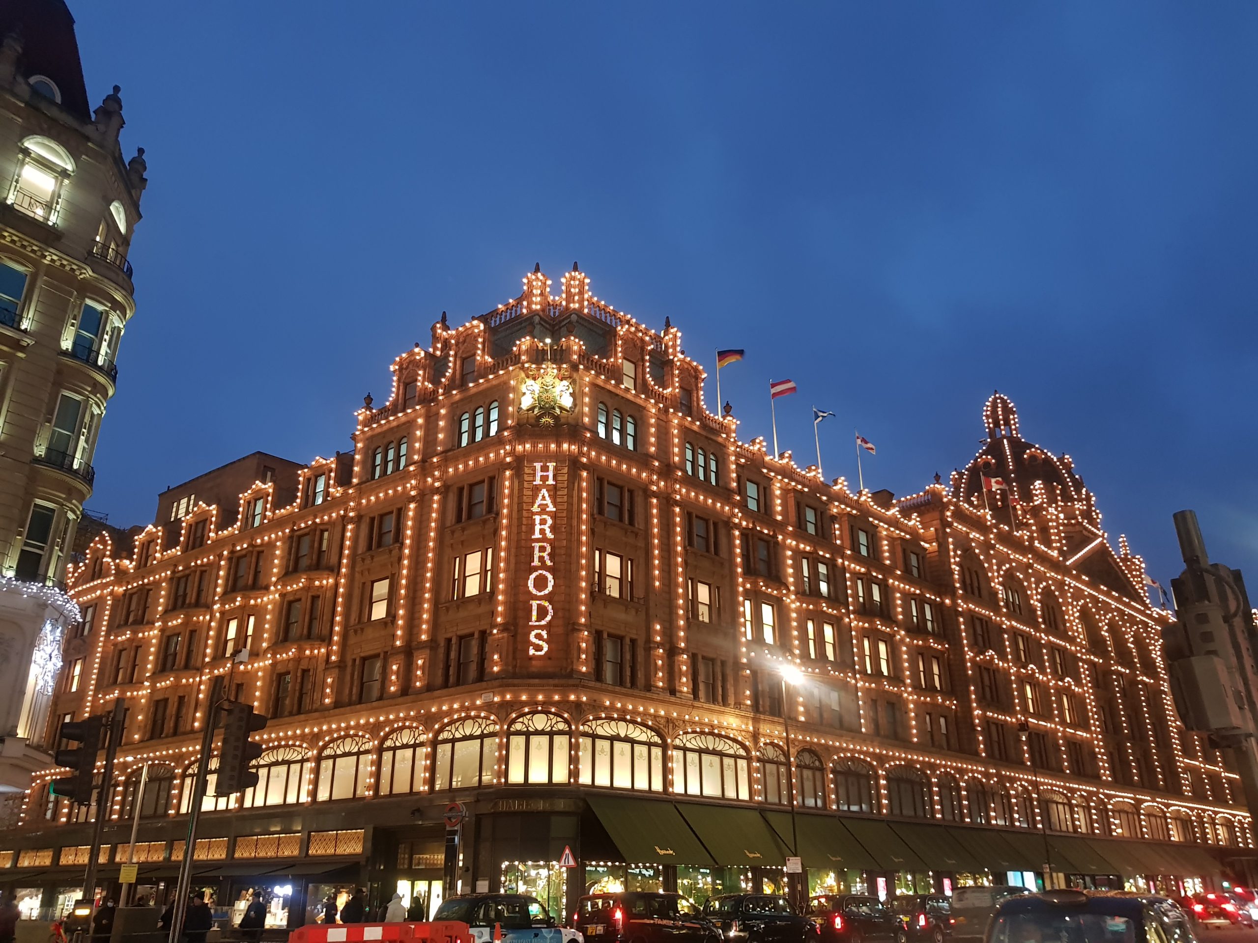 A picture of the outside of harrods department store, all covered with fairy lights