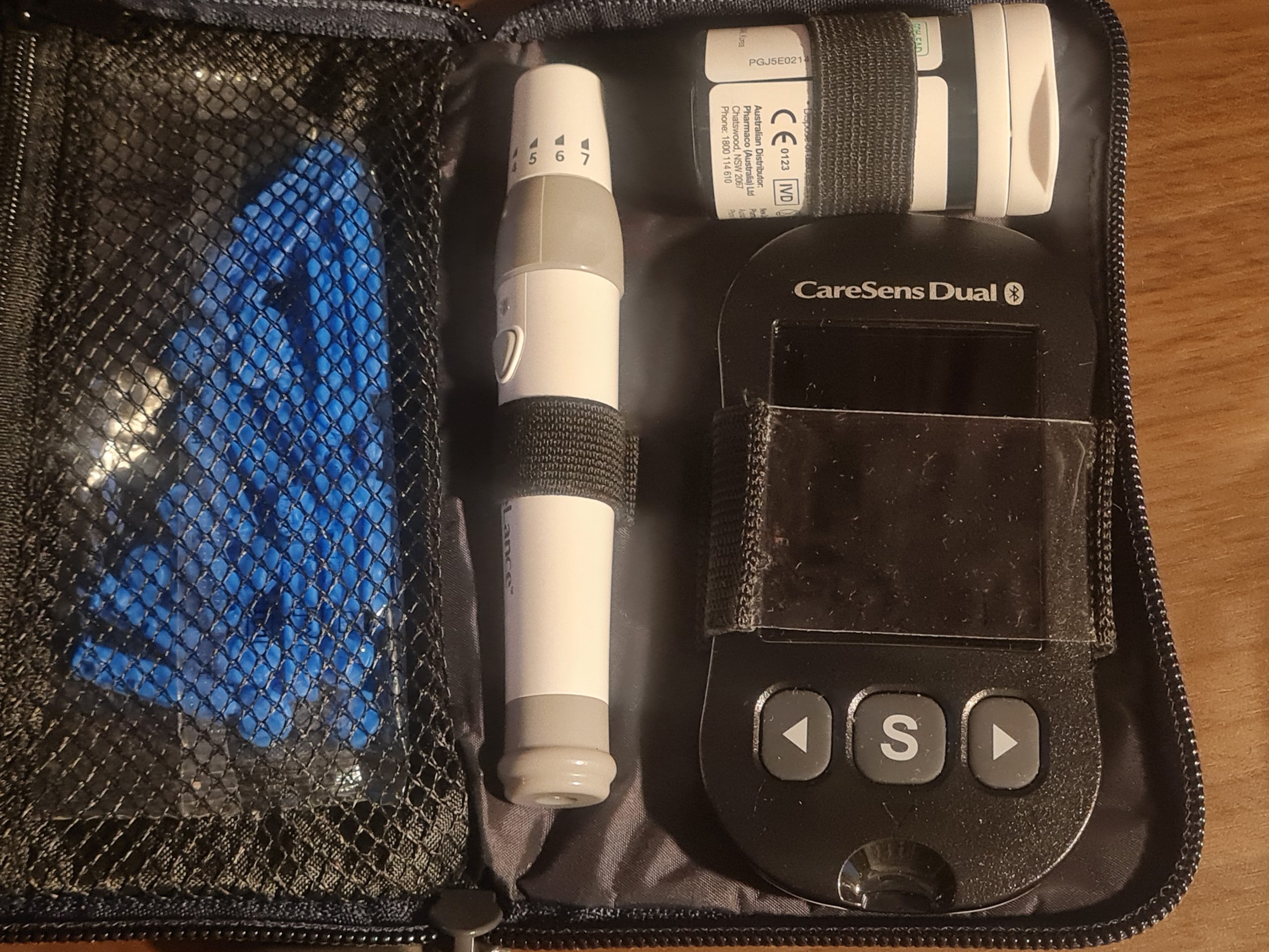 a photo of a glocose monitor with test strips and lancets.