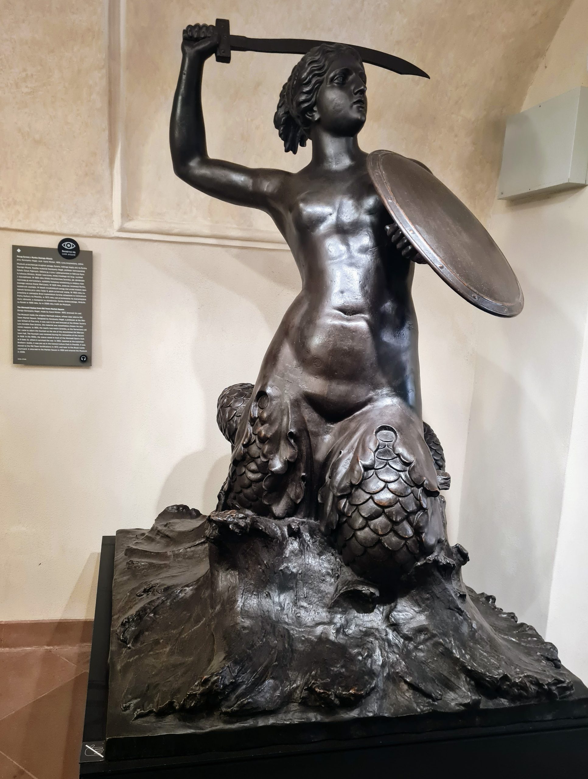 The original Mermaid statue that was the centrepiece of the fountain in the main square of the old town warsaw. The Mermaid is holding her sword up behind her head in her right hand with a shield protecting her body in her left