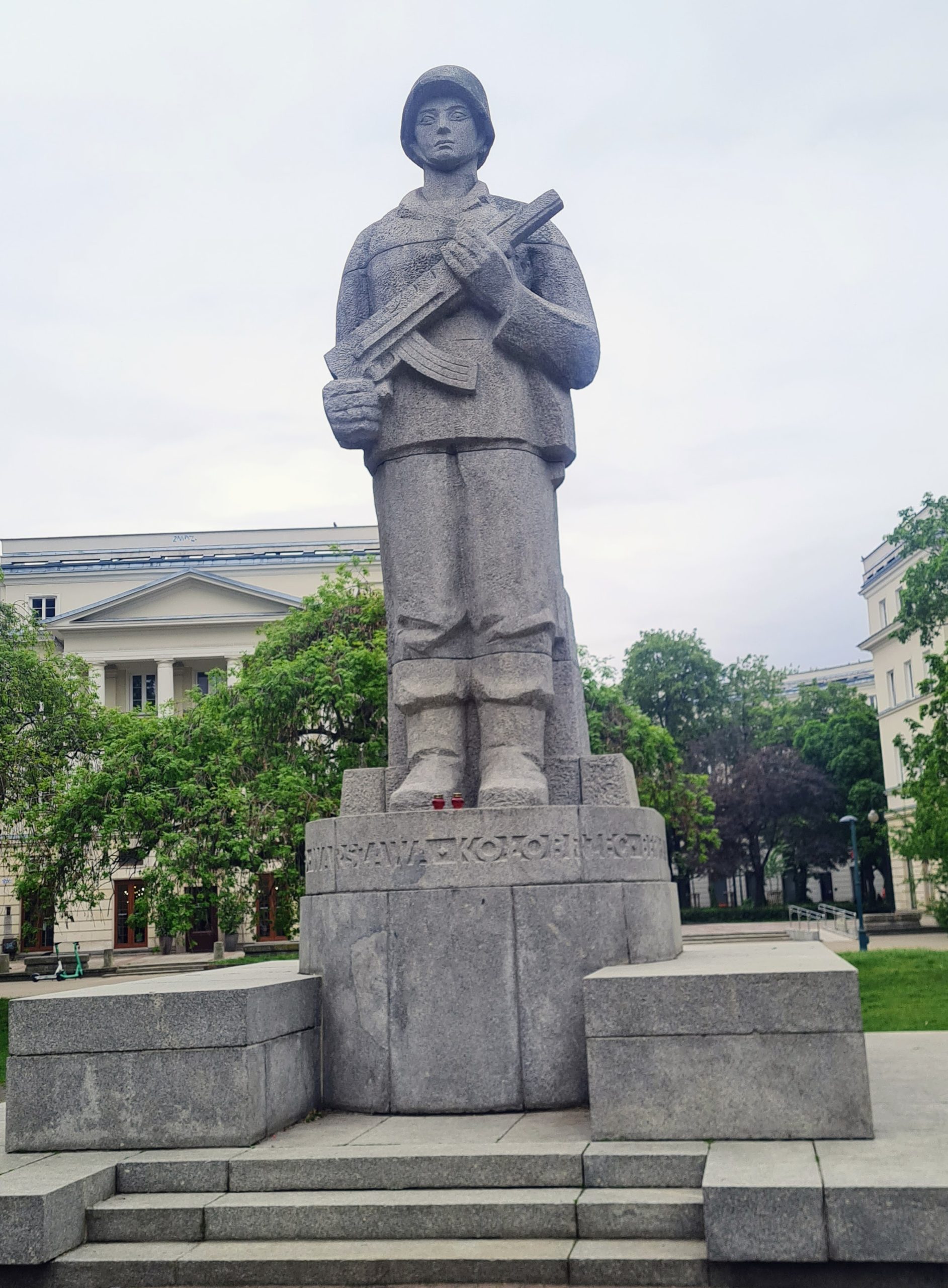 a statue of a soldier holding a rifle with both hands